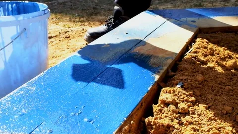 Painting with a brush to paint the elements of the playground in blue Stock Footage 129094956