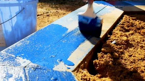 Painting with a brush to paint the elements of the playground in blue Video stock 129095004