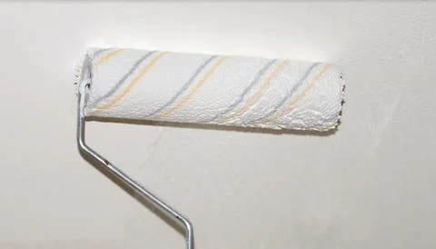 Painting the ceiling with a paint roller Stock Photos