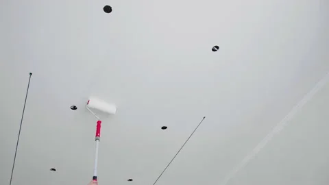 Painting ceiling in white with a roller. DIY home repair. Stock Footage 148231375
