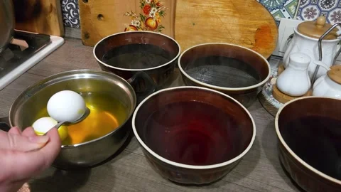 Painting chicken Easter eggs, dipping into water with multi-colored dyes Stock Footage 243573091
