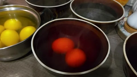 Painting chicken Easter eggs, dipping into water with multi-colored dyes Stock Footage 243573149