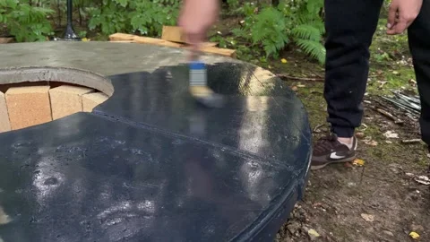 Painting DIY Concrete Fire Pit Table with Black Paint Video stock 342630864