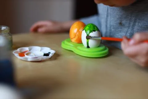Painting easer egg hand with brush close up Stock Photos