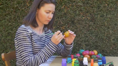 Painting Easter egg outdoors Video stock 83549131