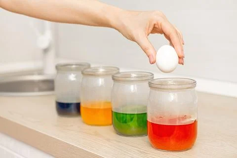 Painting easter eggs at home, close-up. Stock Photos