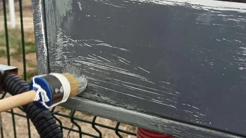 Painting the electrical panel with gray paint on a cloudy day Stock Footage 119804551