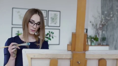 Painting girl is smiling while posing Stock Footage 74642312