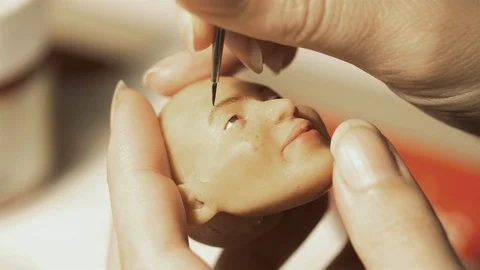 Painting a hand made puppet head by hand 스톡 동영상 89906647