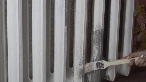 Painting the heating radiator in white Stock Footage 116129786