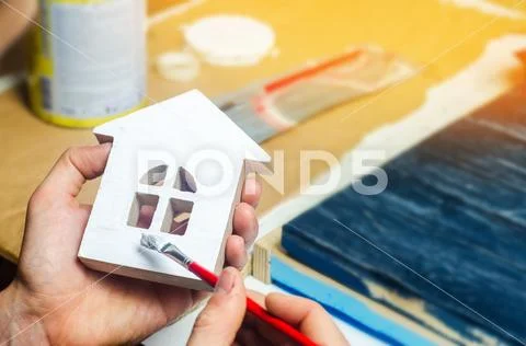 Painting the house, repairing , painting the facade of the building, trim wor Stock Photos
