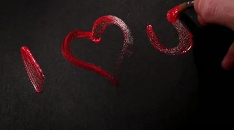 Painting 'I <3 You' in Red Paint on Black Card HD Stock Footage