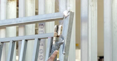 Painting a metal gate in a workshop action sequence industrial environment Stock Footage 330986606