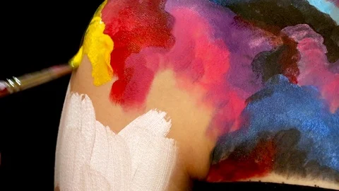 Painting on models body with brush. Macro footage of art bodypainting. Stock Footage 103440434