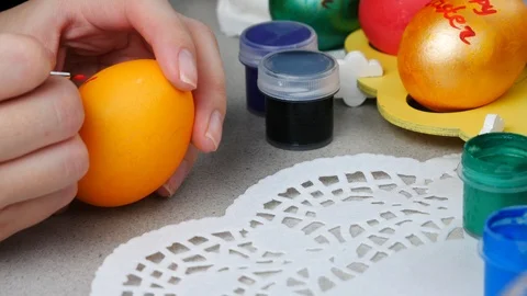 Painting an orange Happy Easter egg Stock Footage 87857538