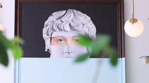 A painting of a plaster bust hangs on the wall with green flowers. Clay bust. Pl Stock Footage 155377273