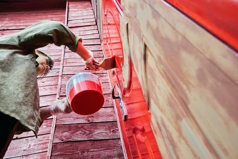 Painting process with flat paint brush conducted by house painter on metal .. Stock Photos