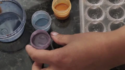 Painting sections of a mold with a paint made from cocoa butter. Stock Footage 132800317