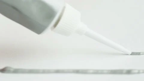 Painting silver line close-up. Squeezing grey paint out of a tube. Craft Stock Footage 171470597
