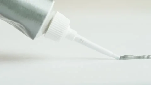 Painting silver line close-up. Squeezing grey paint out of a tube. Craft Video stock 171529585