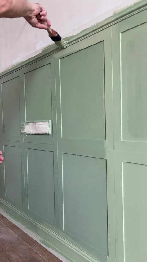 Painting wall-mounted MDF panels with interior green paint in the bedroom Stock Footage 346691492