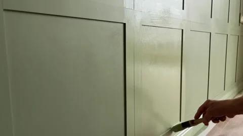 Painting wall mounted MDF panels with interior green paint in the bedroom Stock Footage 346692290
