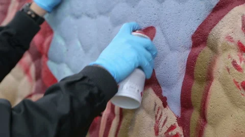Painting a wall with red spray paint Video stock 48200064
