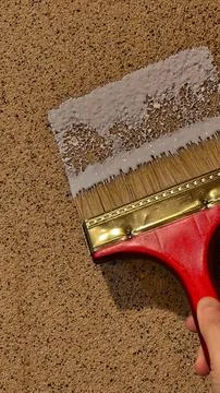 Painting wall surface concept using wide brush for home renovation Foto stock