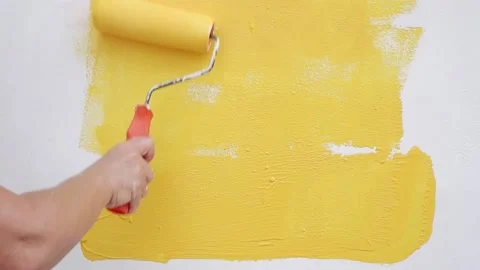 Painting wall on yellow  Stock Footage 154336647