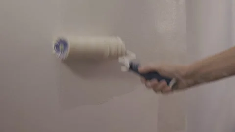 Painting white  wall with roller Stock Footage 345842917