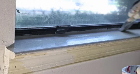 Painting window frame with brush inside house Stock Footage 342744044