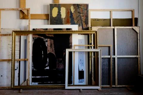 Paintings and frames leaning on wall 스톡 사진