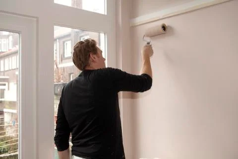 Paintroller on wall Stock Photos