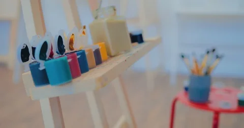 Paints are placed on the easel. Workplace of the artist in the art studio. Stock Footage 106252132
