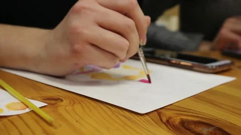 Paints, brushes and albums on the table. Shooting drawing top view Stock Footage 144882717