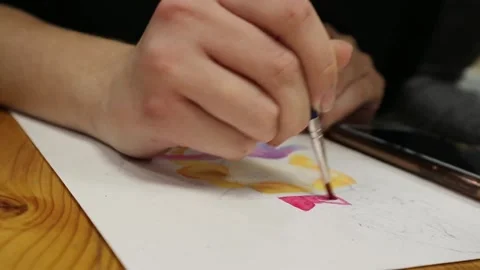 Paints, brushes and albums on the table. Shooting drawing top view Stock Footage 144882797