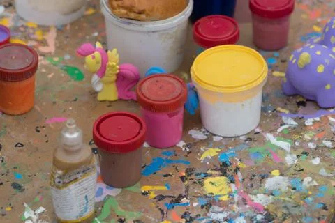 Paints in cans on the table Stock Photos