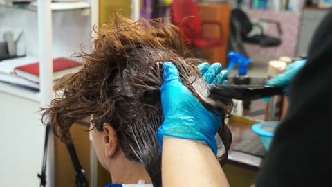 Paints hair with a comb Stock Footage 87584465
