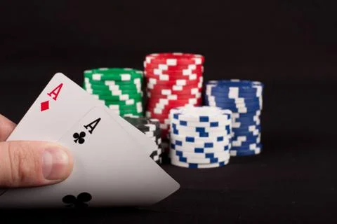Pair of aces and poker chips on dark background Stock Photos