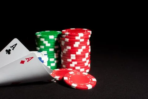 Pair of aces and poker chips on dark background Stock Photos