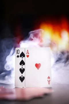 A pair of aces on a deck of playing cards in a smoke Stock Photos