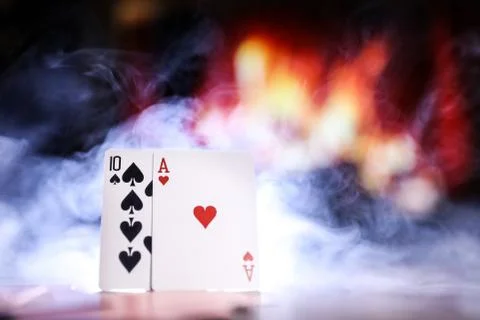 A pair of aces on a deck of playing cards in a smoke Stock Photos