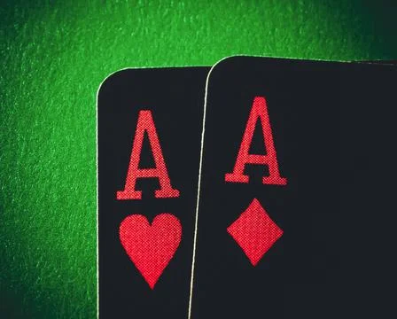 A pair of aces on a green background, close up shot. Ace of hearts and ace of Foto stock