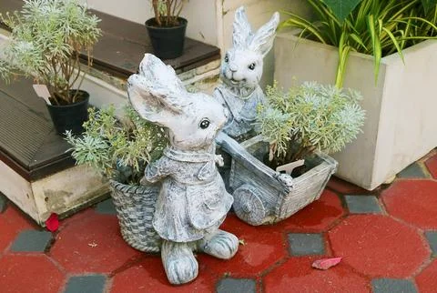 Pair of Adorable Stone Easter Bunny Sculptures in the Patio Stockfoto's