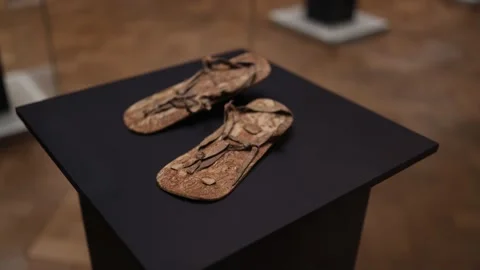 A pair of ancient handcrafted sandals made from natural materials, showcasing in Stock Footage 293467396