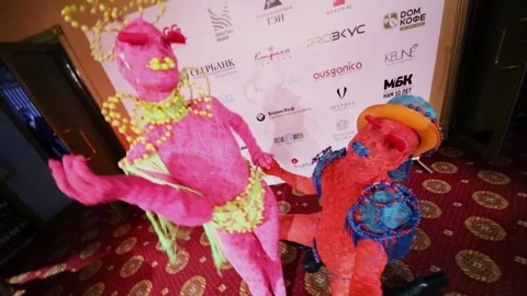 Pair of animators in lace suits dances near press wall during Award Records of Stock Footage 276371815