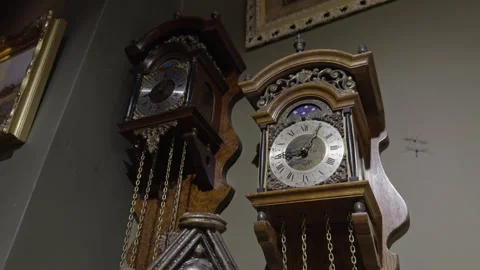Pair of Antique Bracket Clocks Hanging on Wall Stock Footage 346041519