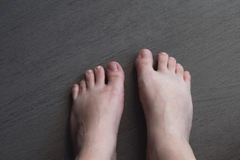 A pair of bare feet on the ground Stock Photos