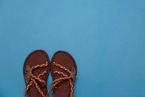 Pair of beach flip-flops on the blue background summer concept. Stock Photos