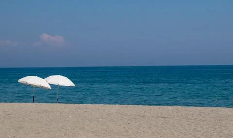 Pair of beach umbrellas on a beach Foto stock
